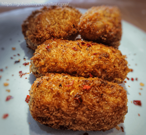 close up view of Italian potato croquettes on a white ceramic plate