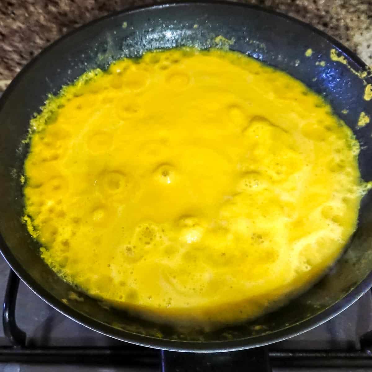 creamy dijon sauce simmering in a pan.