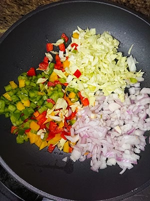 Finely diced vegetables in a non-stick pan.