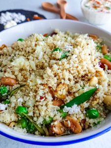 closeup view of coconut cauliflower rice in a large white bowl.