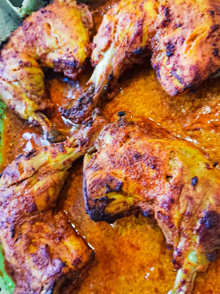 tandoori chicken in oven - roasted chicken legs from the ovenwhole chicken legs on white ceramic plates