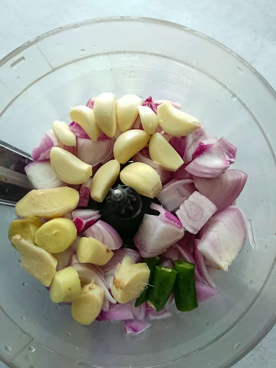 ingredients for Indian curry paste recipe in a food processor jar.