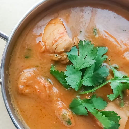 closeup view of 5 ingredient easy chicken curry without coconut milk in a stainless steel bowl.