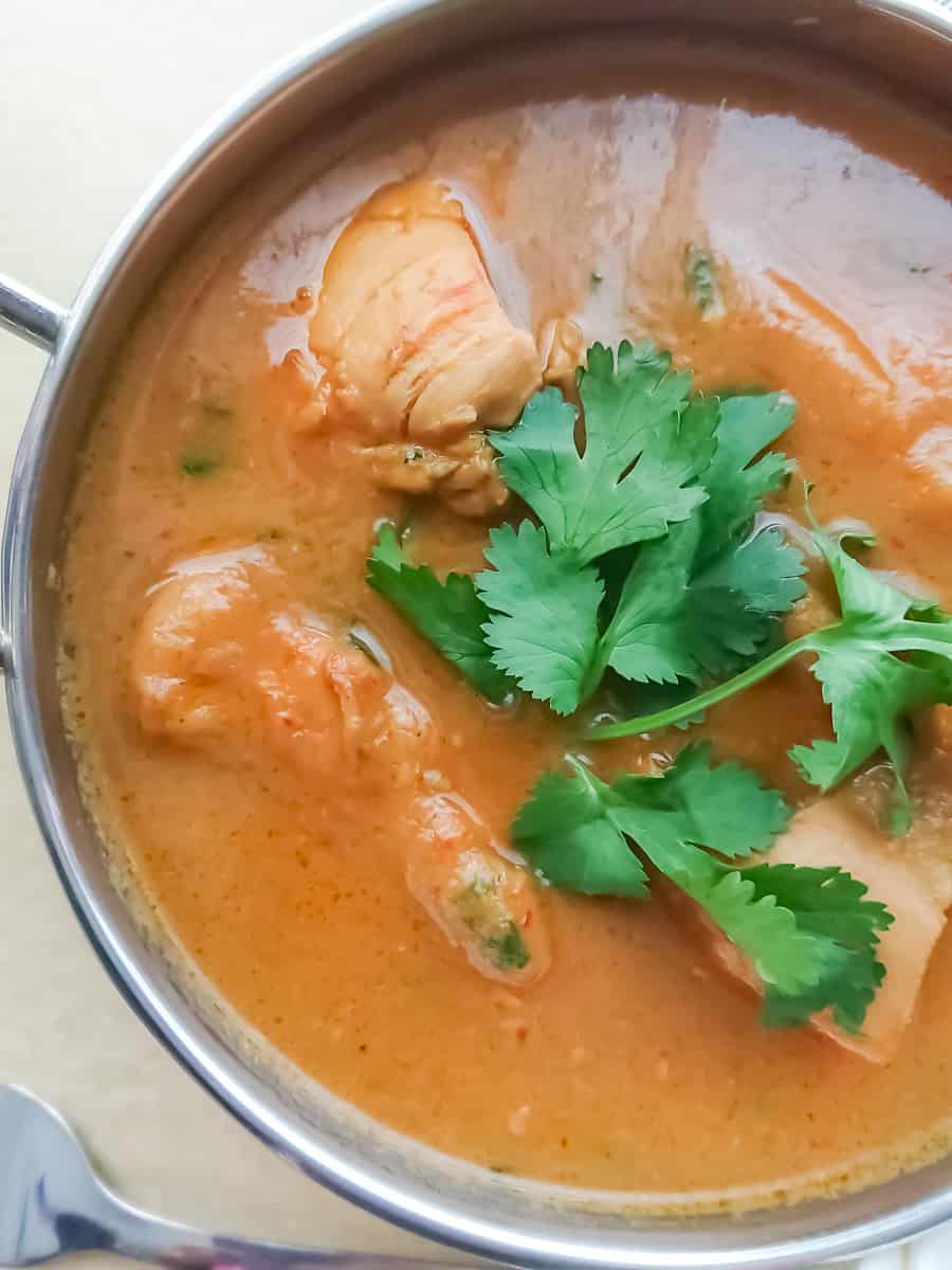 closeup view of 5 ingredient easy chicken curry without coconut milk in a stainless steel bowl.