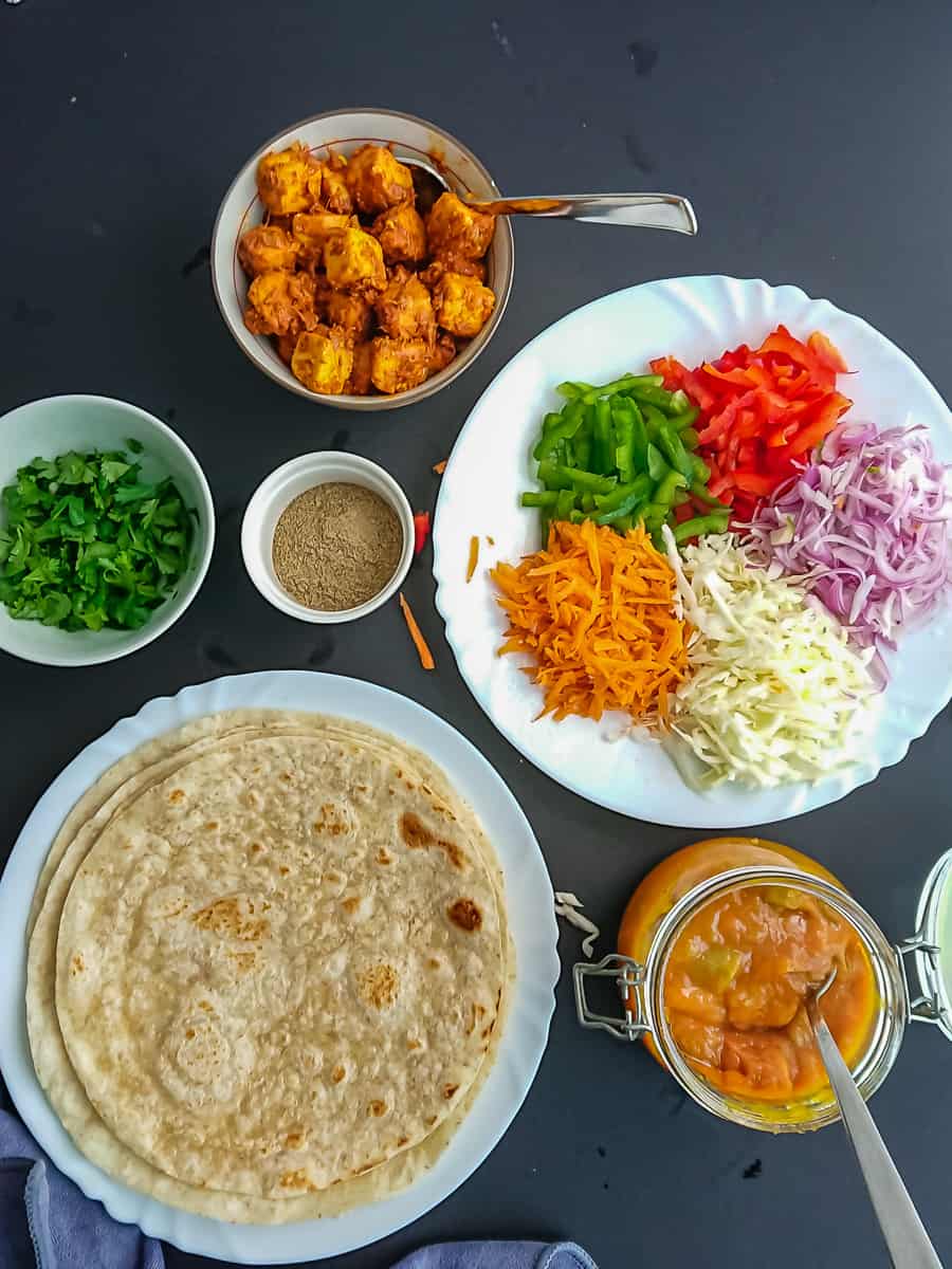 paneer kathi roll ingredients- flour tortillas, mango chutney, veggies, chaat masala and coriander leaves