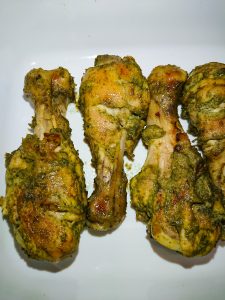 baked pudina chicken legs on a white tray.