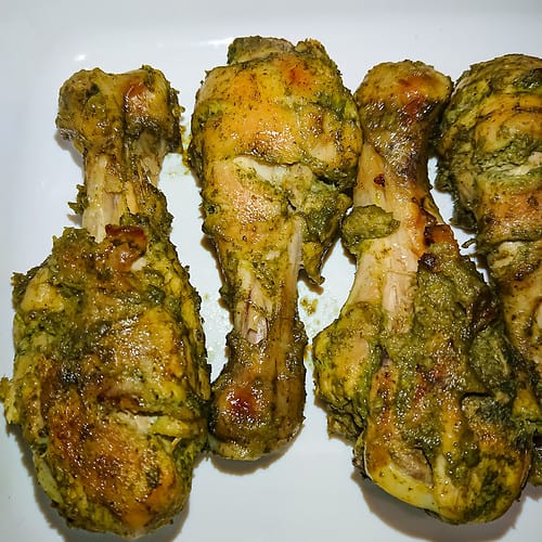 baked pudina chicken legs on a white tray.