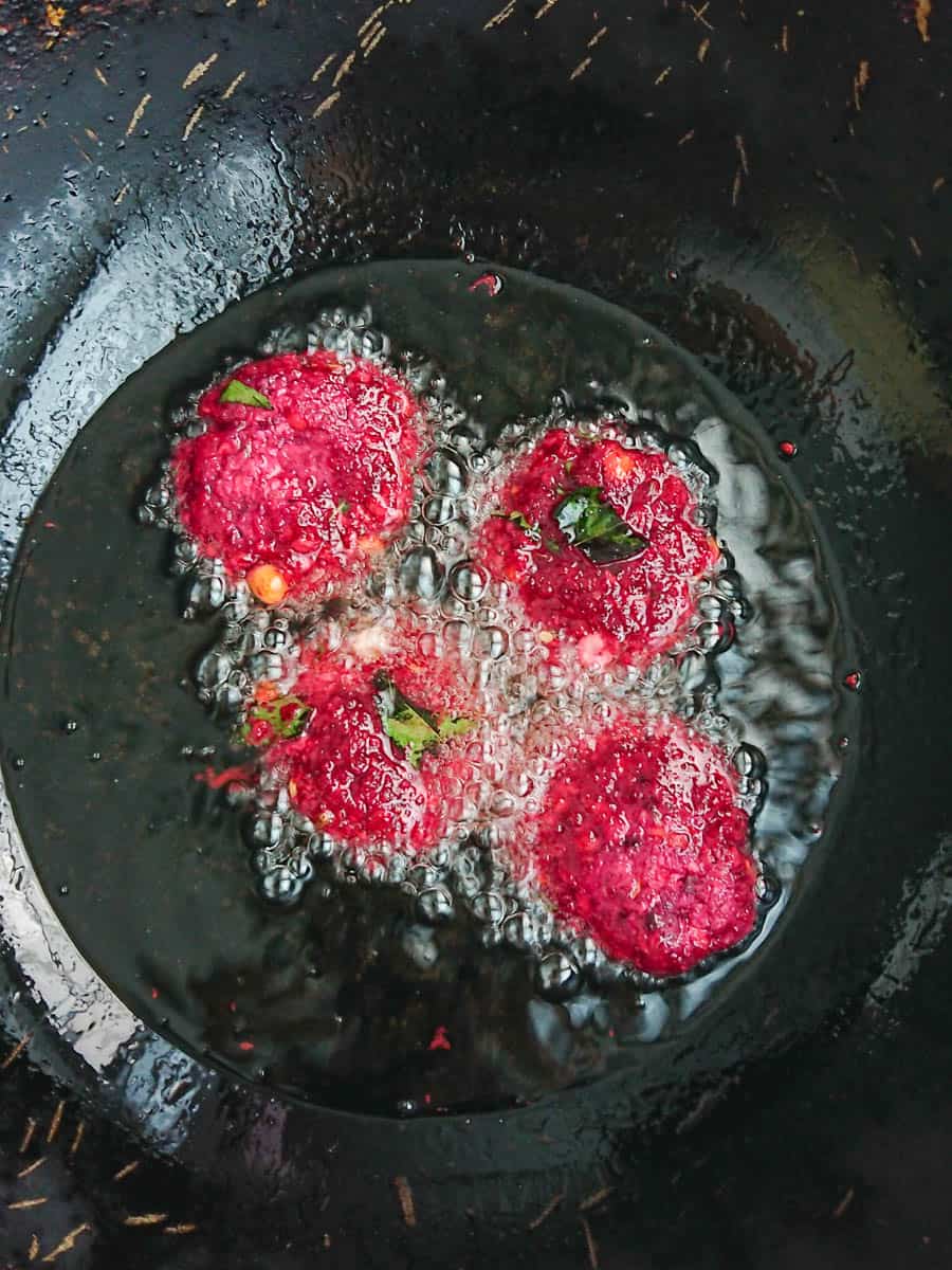 beetroot masala vada being fried in oil