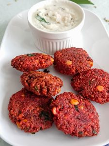 beetroot paruppu vadai in a white plate served with coconut chutney