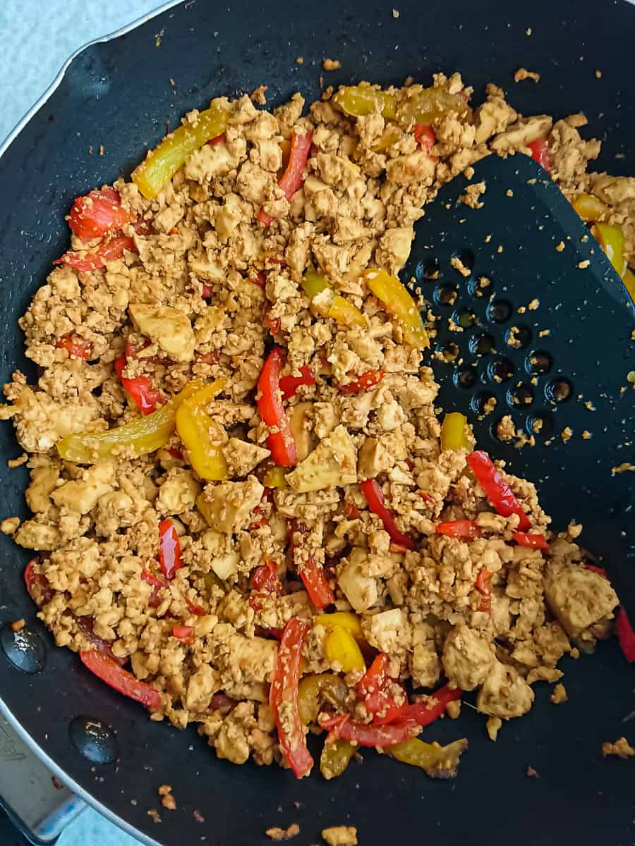 Asian Chili Garlic Tofu Scramble chili garlic tofu in a non-stick cooking pan.