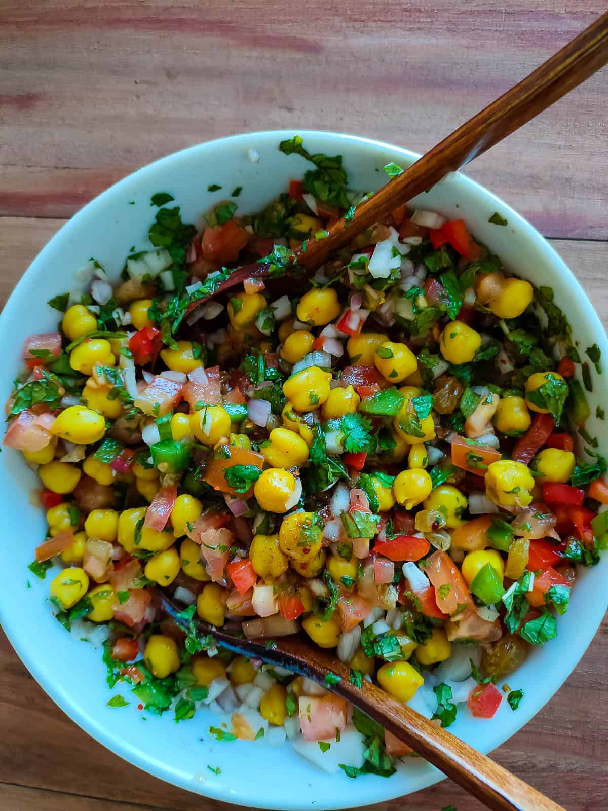 Chana chaat salad in a white bowl.