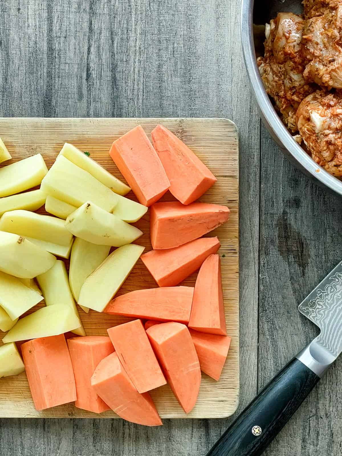 Potatoes and sweet potatoes cut into wedges for baked chicken drumsticks & potatoes recipe.