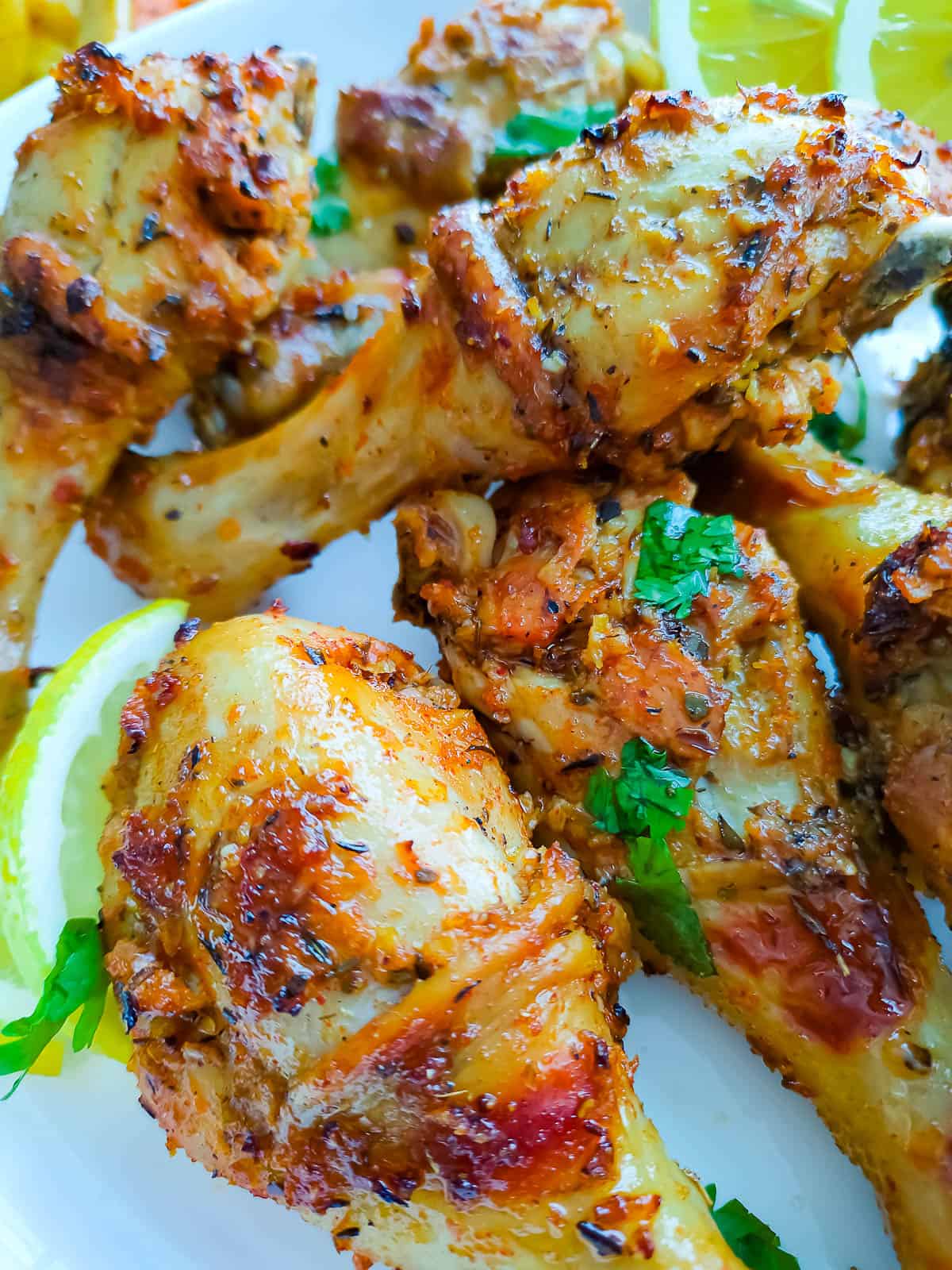 Closeup view of sheet pan baked chicken legs roasted with lemon herb seasoning.