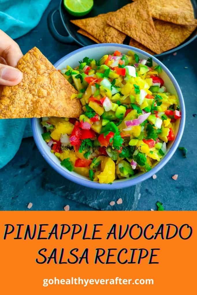 pineapple avocado salsa in a white bowl and wholewheat tortilla chips in a black plate in a small bowl.