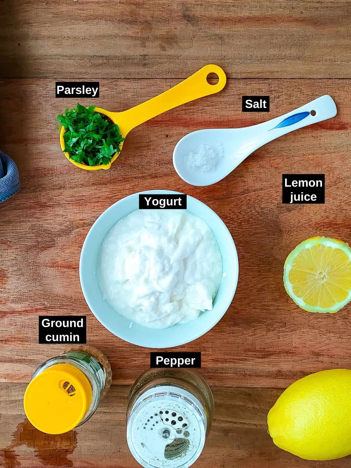 Labelled ingredients to make yogurt sauce for crumb-topped baked fish.