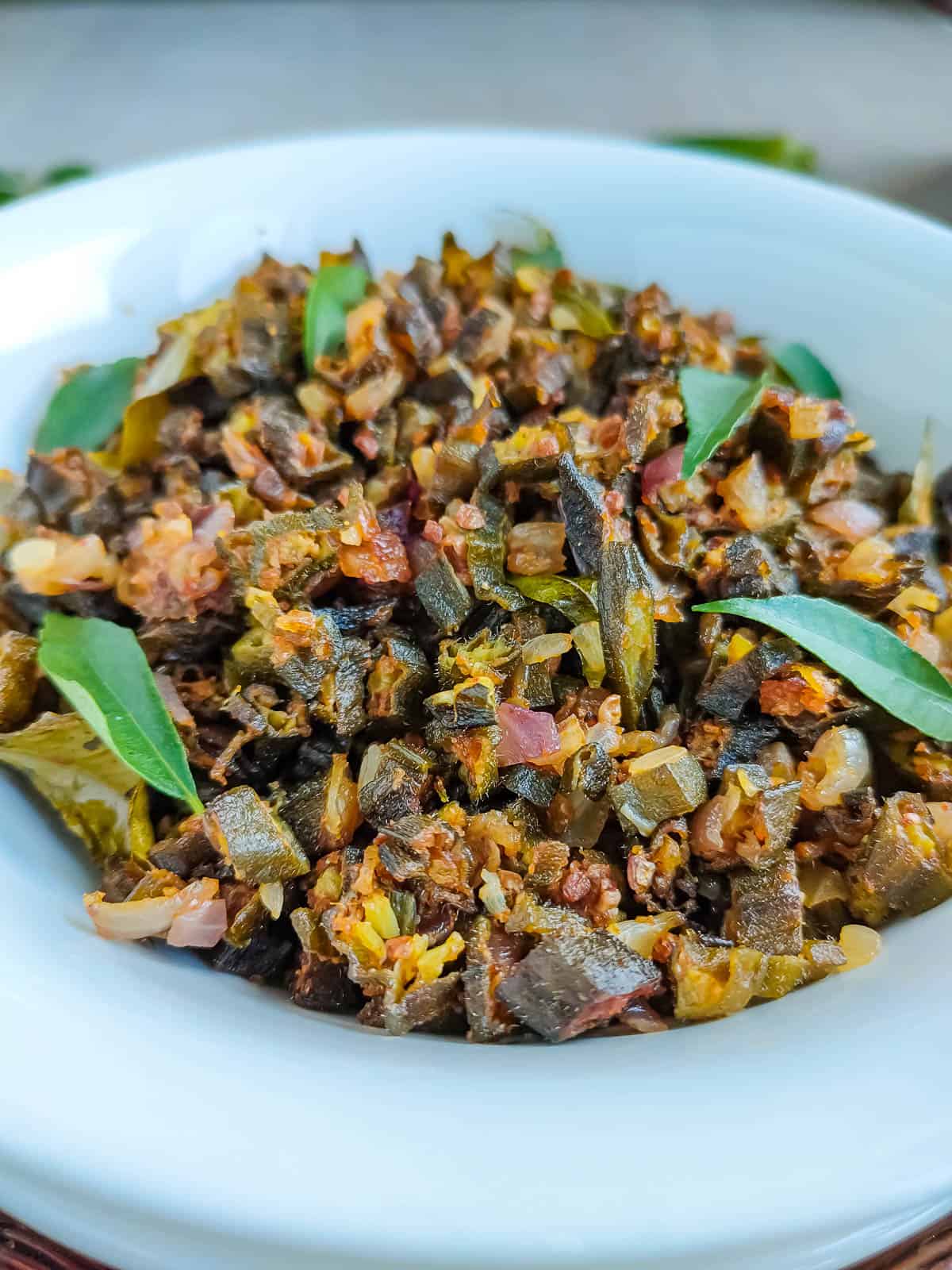 Closeup view of microwave vendakkai poriyal in a white plate.