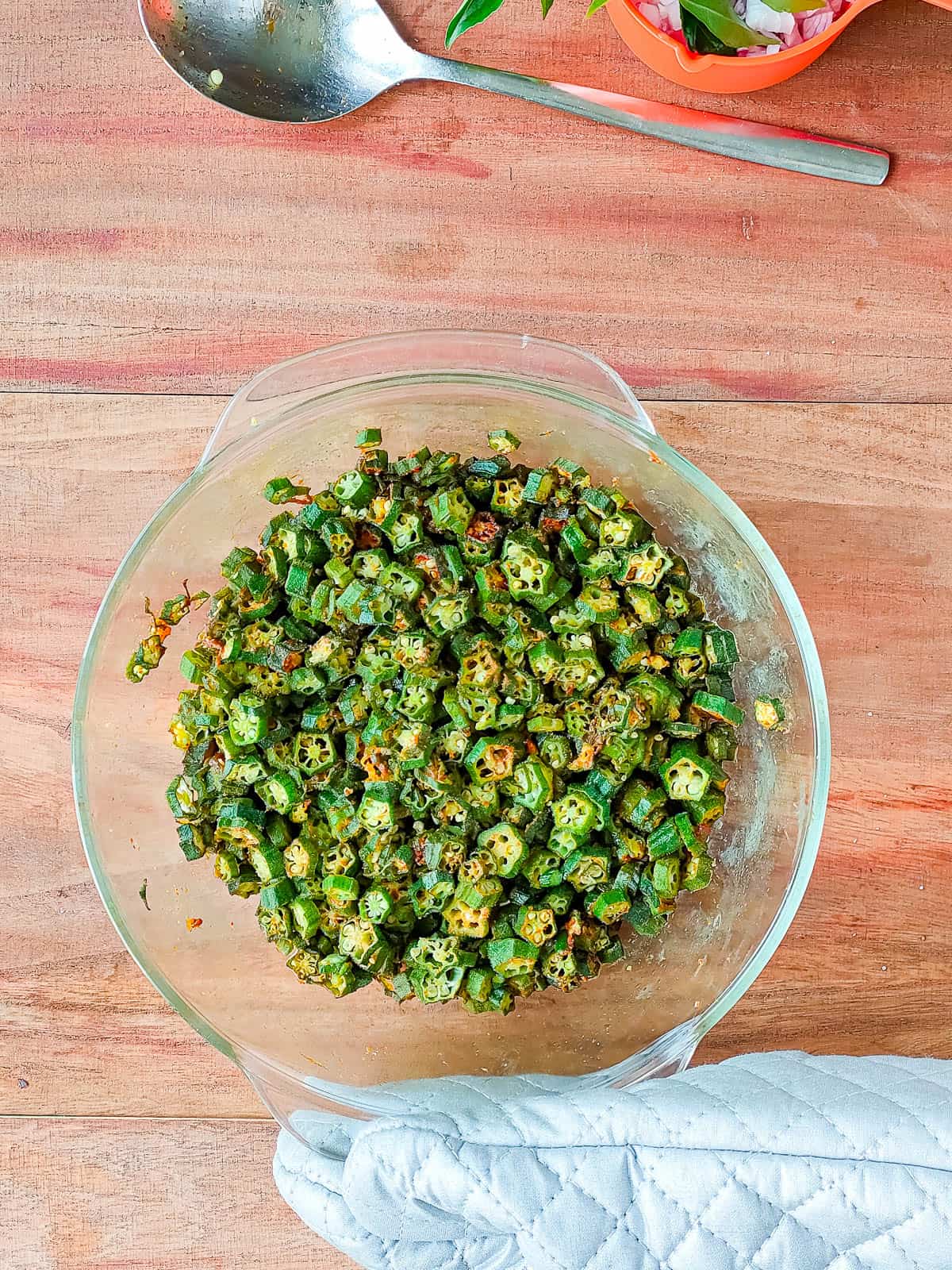 partially cooked ladies finger in a glass bowl.