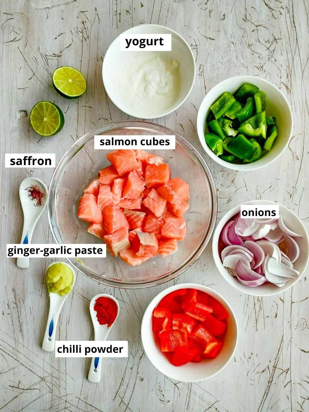Labelled ingredients for saffron salmon kebabs in oven.