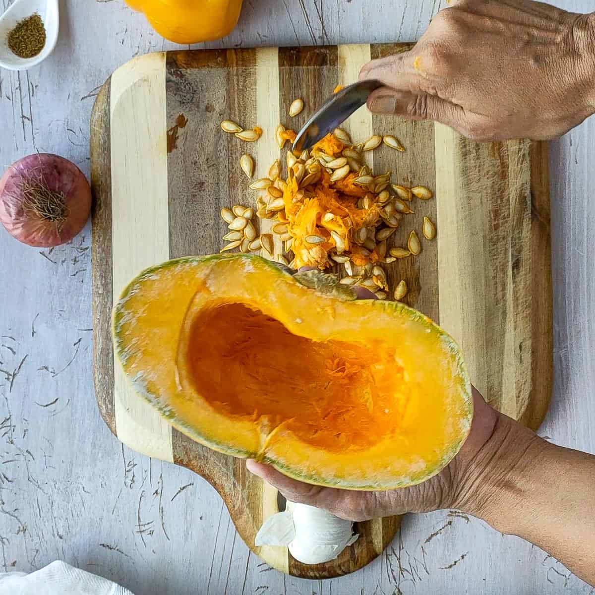 Removing seeds from pumpkin before roasting.