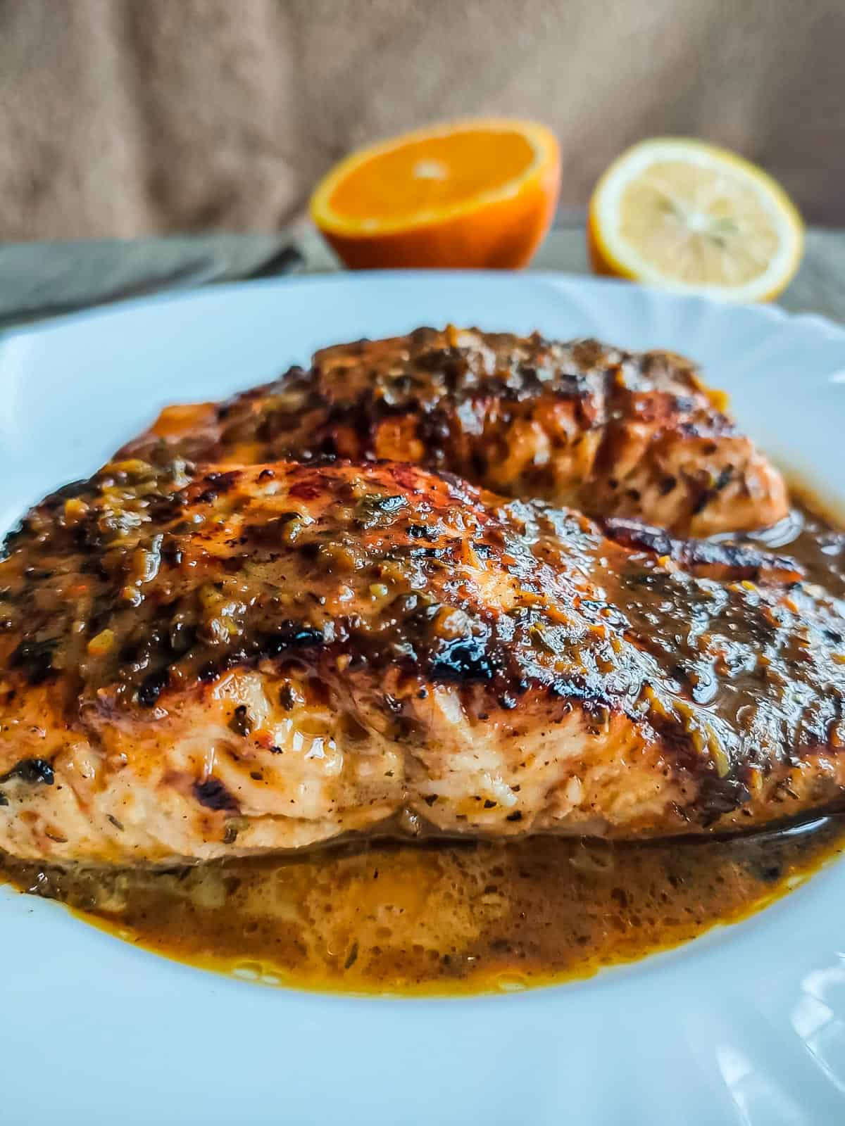 browned butter honey garlic salmon with citrus glaze in a white plate