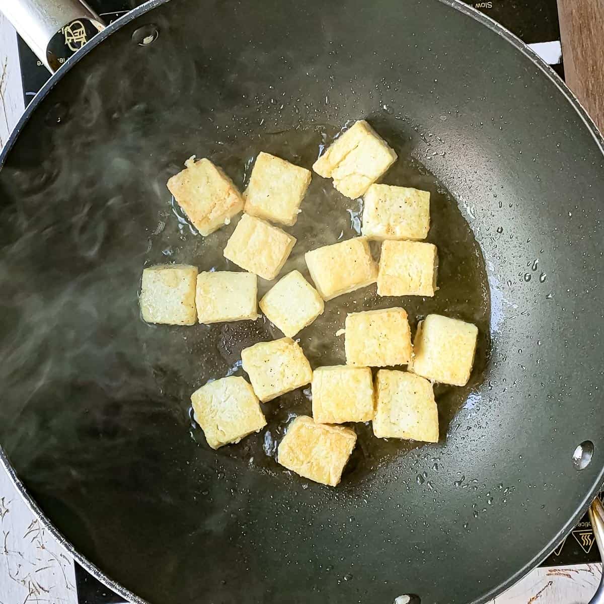 tofu being pan fried.