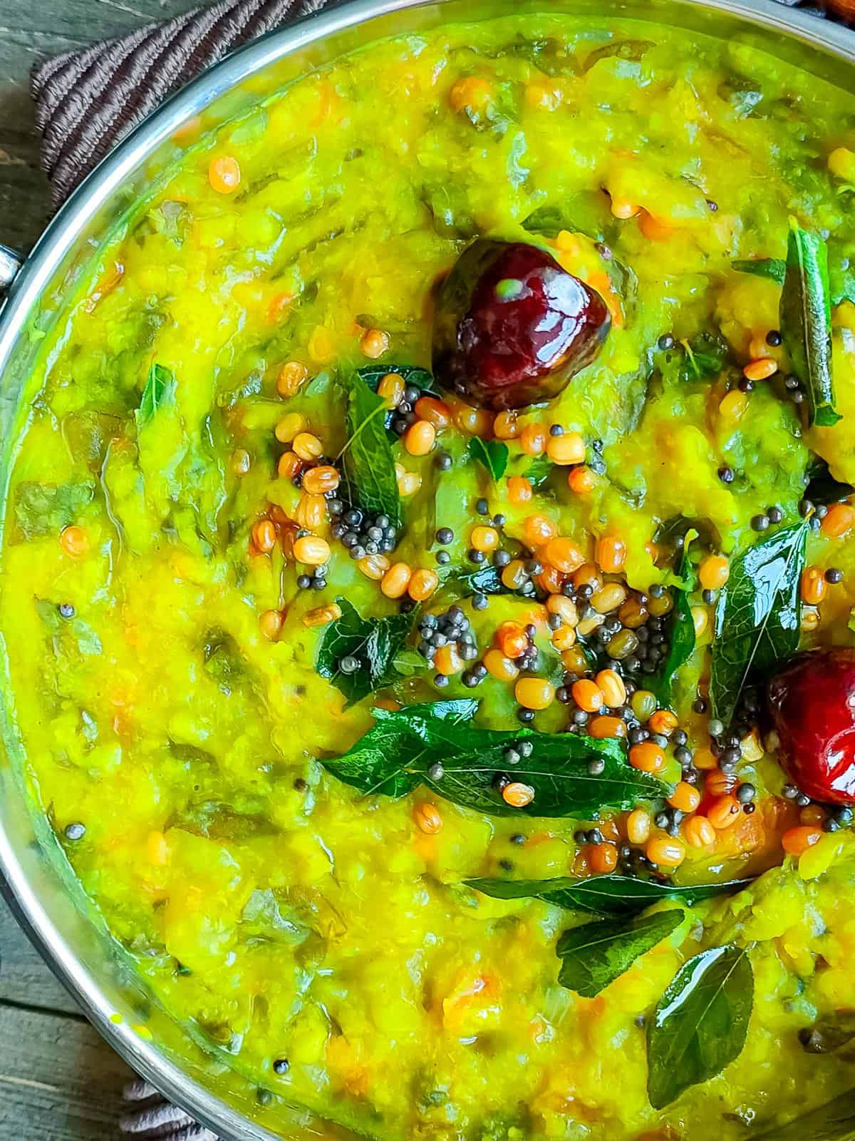 moong dal palak in a metal bowl.