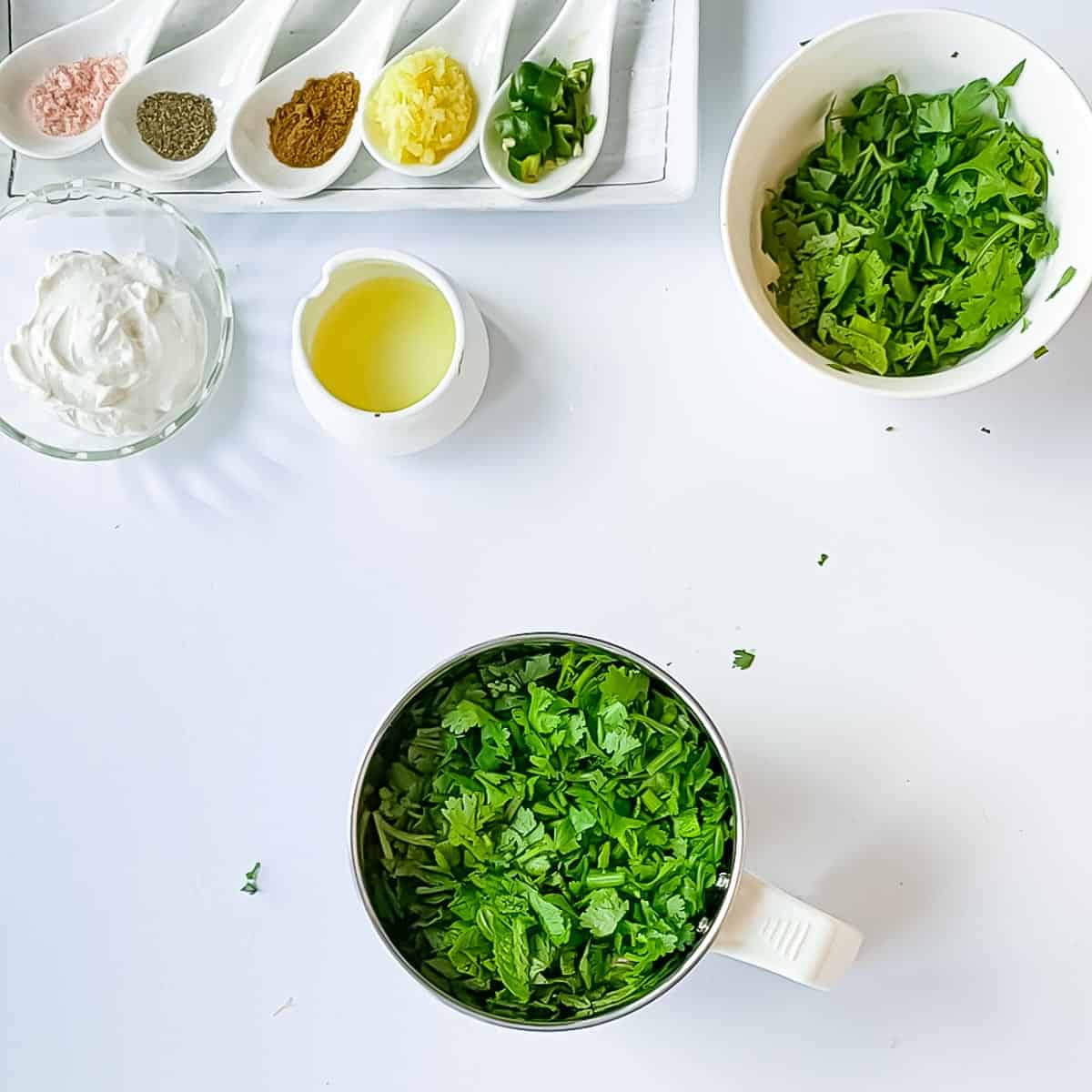 Chopped ingredients for Indian mint sauce recipe in separate bowls.