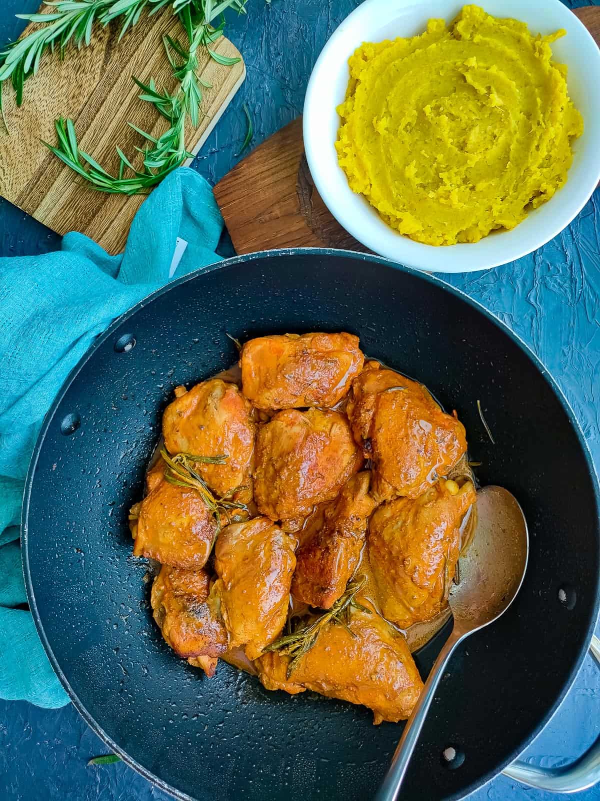 lemon balsamic chicken in a pan and sweet potato mash in a white bowl.