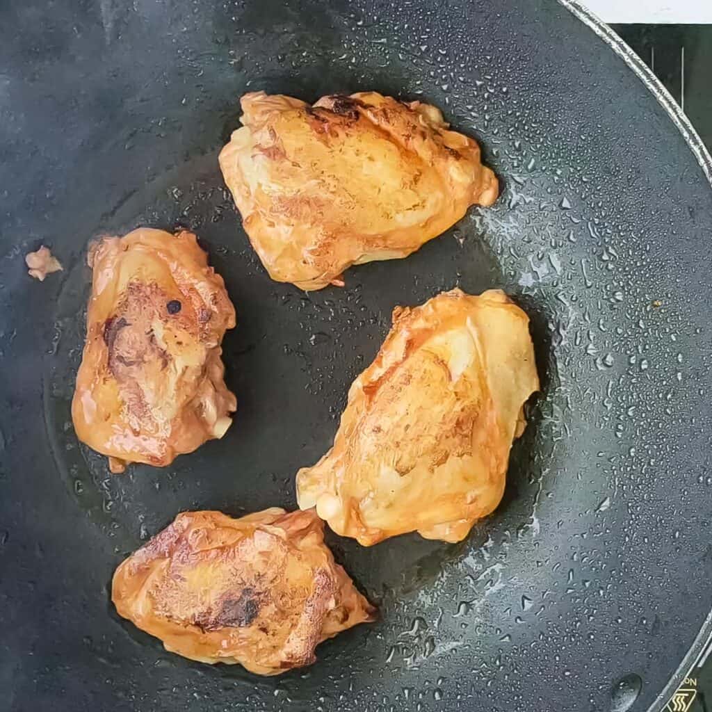 Browned chicken thighs for spicy braised chicken.