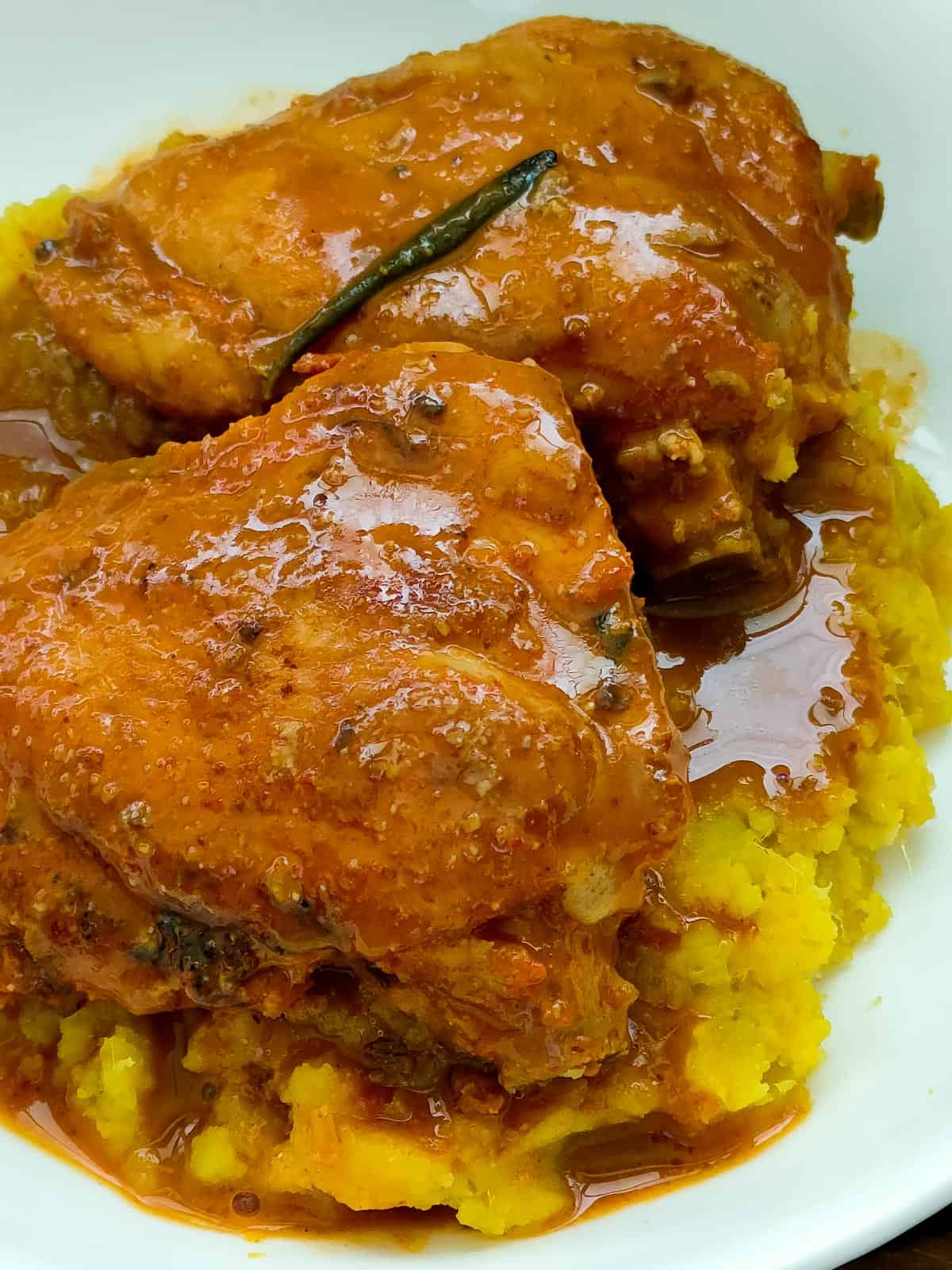 lemon balsamic chicken with rosemary sauce and sweet potato mash on a white plate.