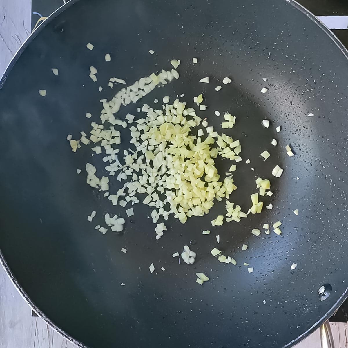 garlic being fried for bok choy tofu stir fry.