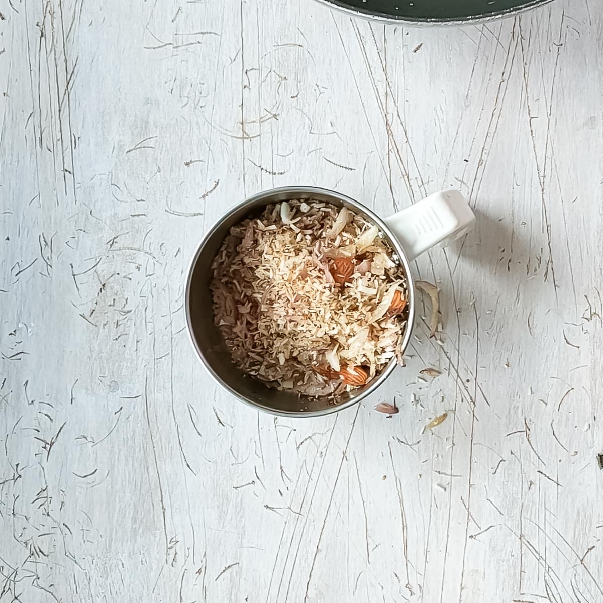 Creamy Chicken Kofta Curry Fried coconut and almonds for chicken kofta curry in a blender jar.