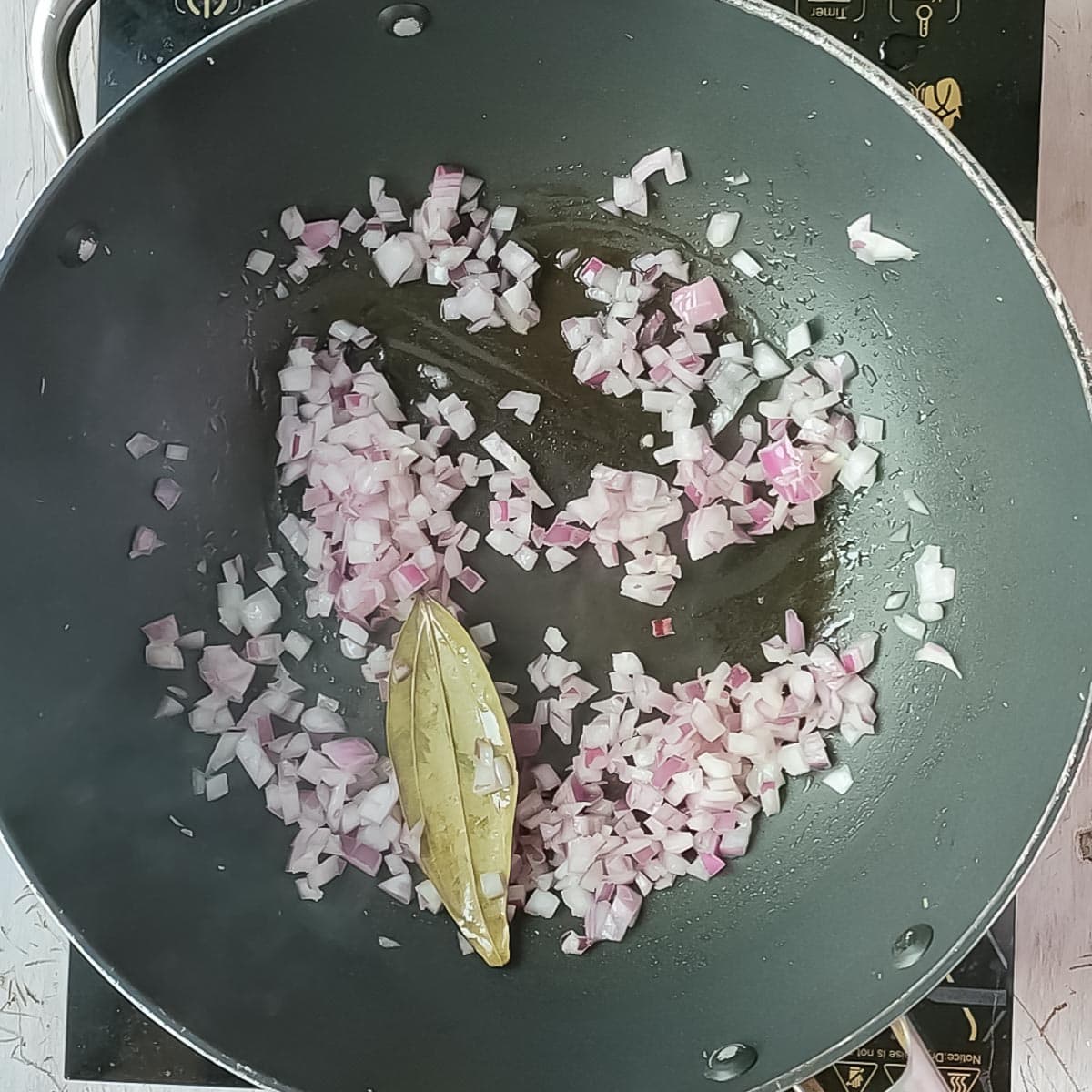Onions being sauteed in a non-stick pan.