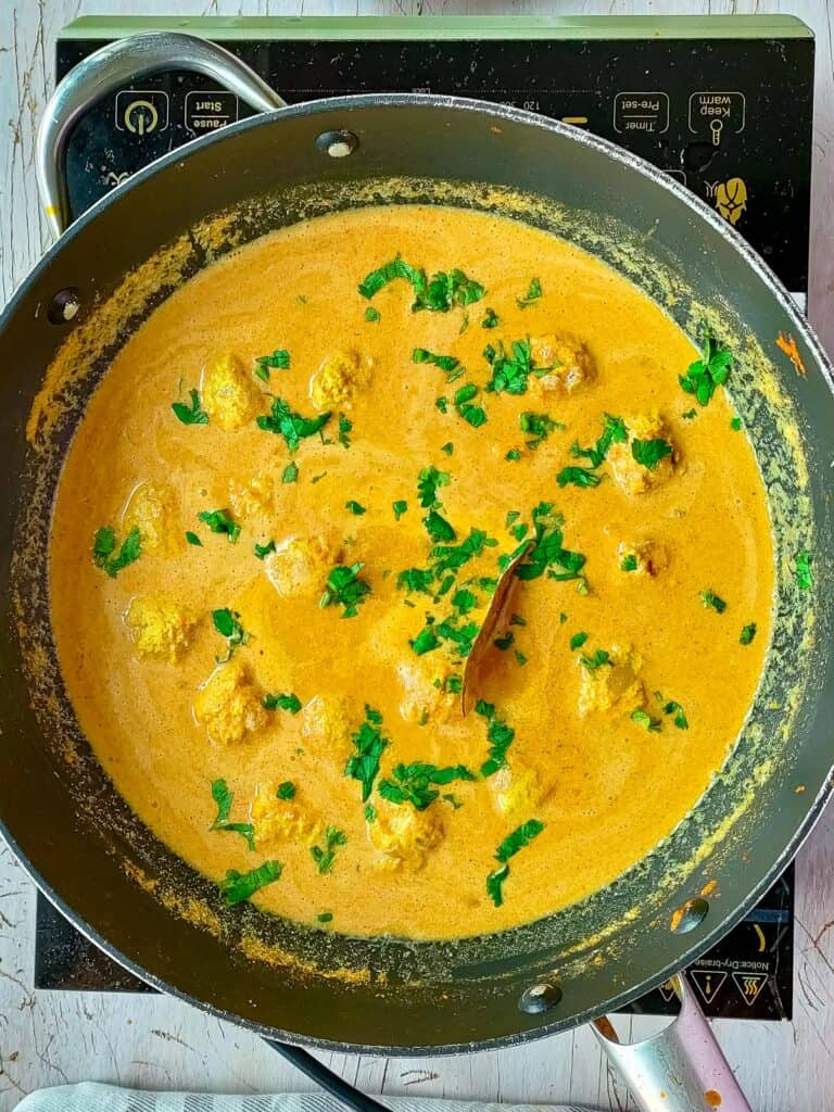 Chicken kofta curry in a non-stick pan.