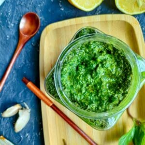 Green chilli pesto with Thai basil in a glass jar.