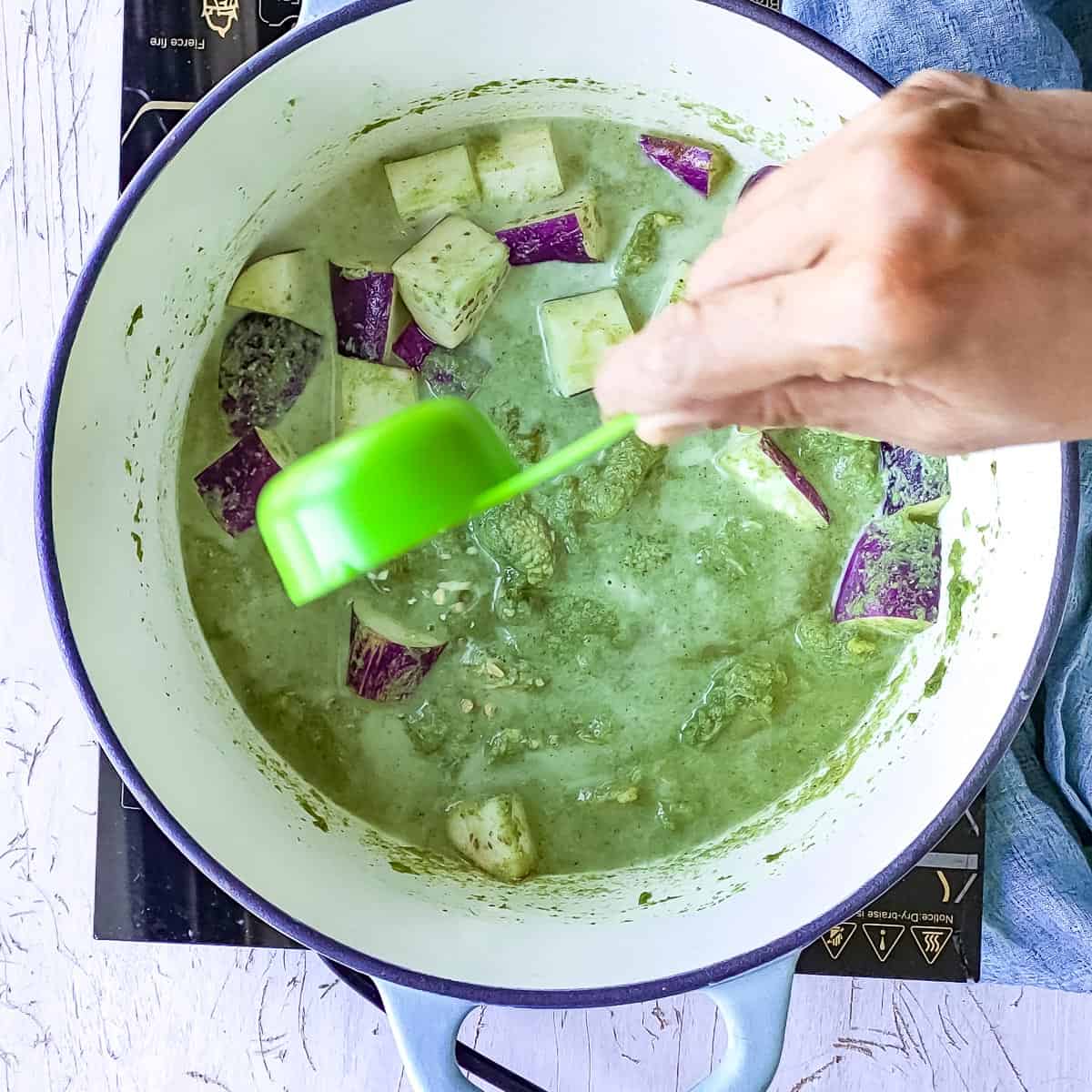 lemon zest being added to green curry.