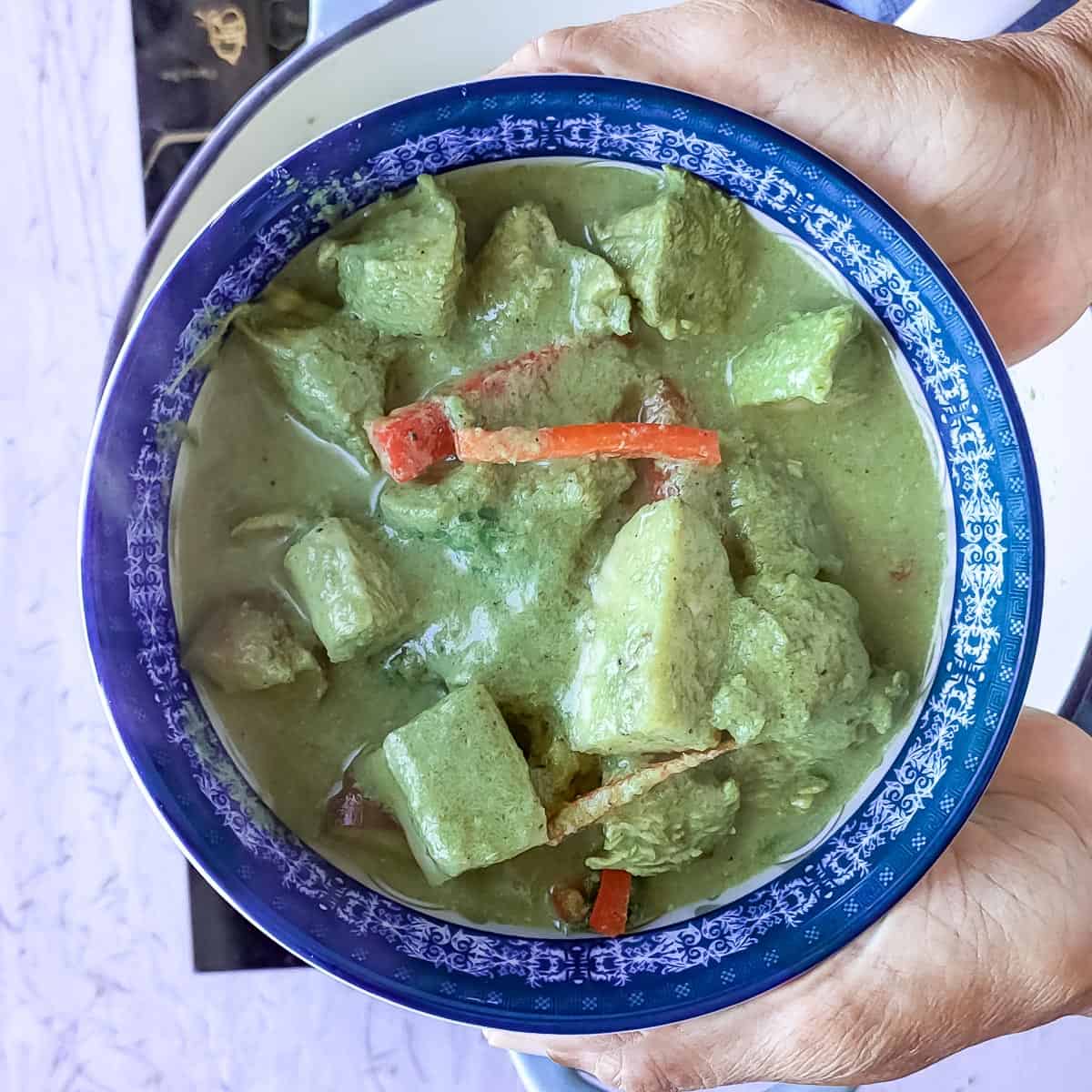 keto Thai chicken curry in a blue bowl.