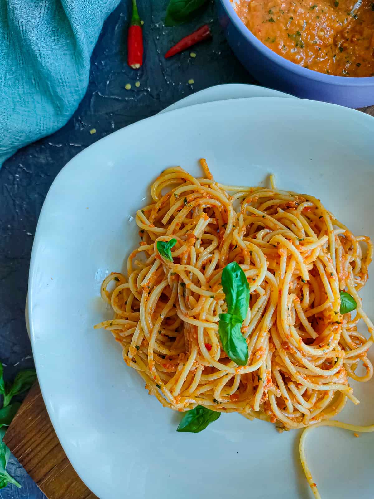 Red pesto pasta on a white plate.