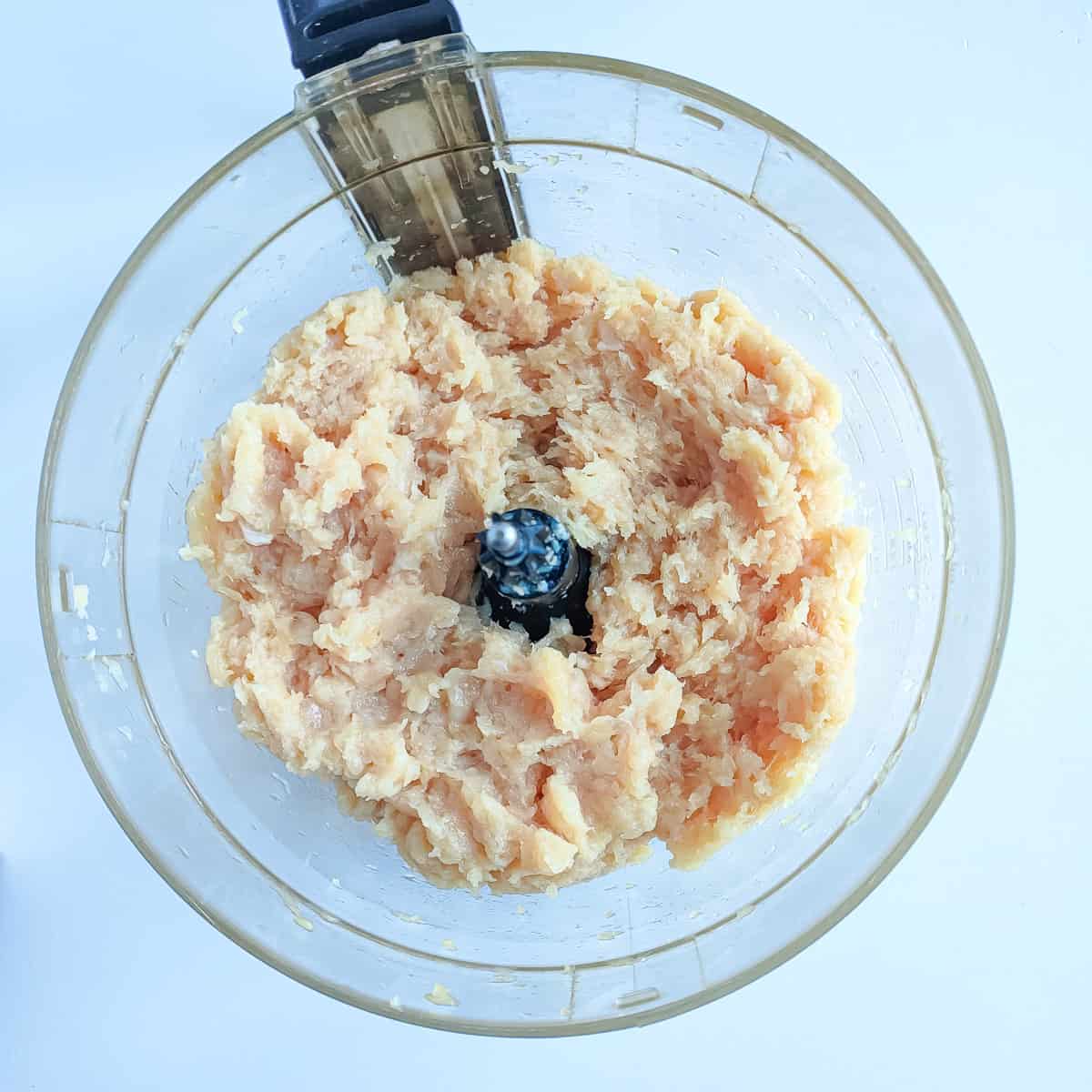 Minced chicken in a food processor jar.