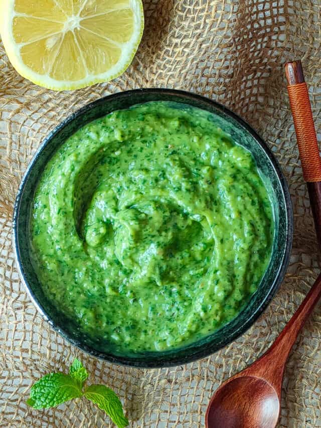 Avocado chutney in a black bowl.