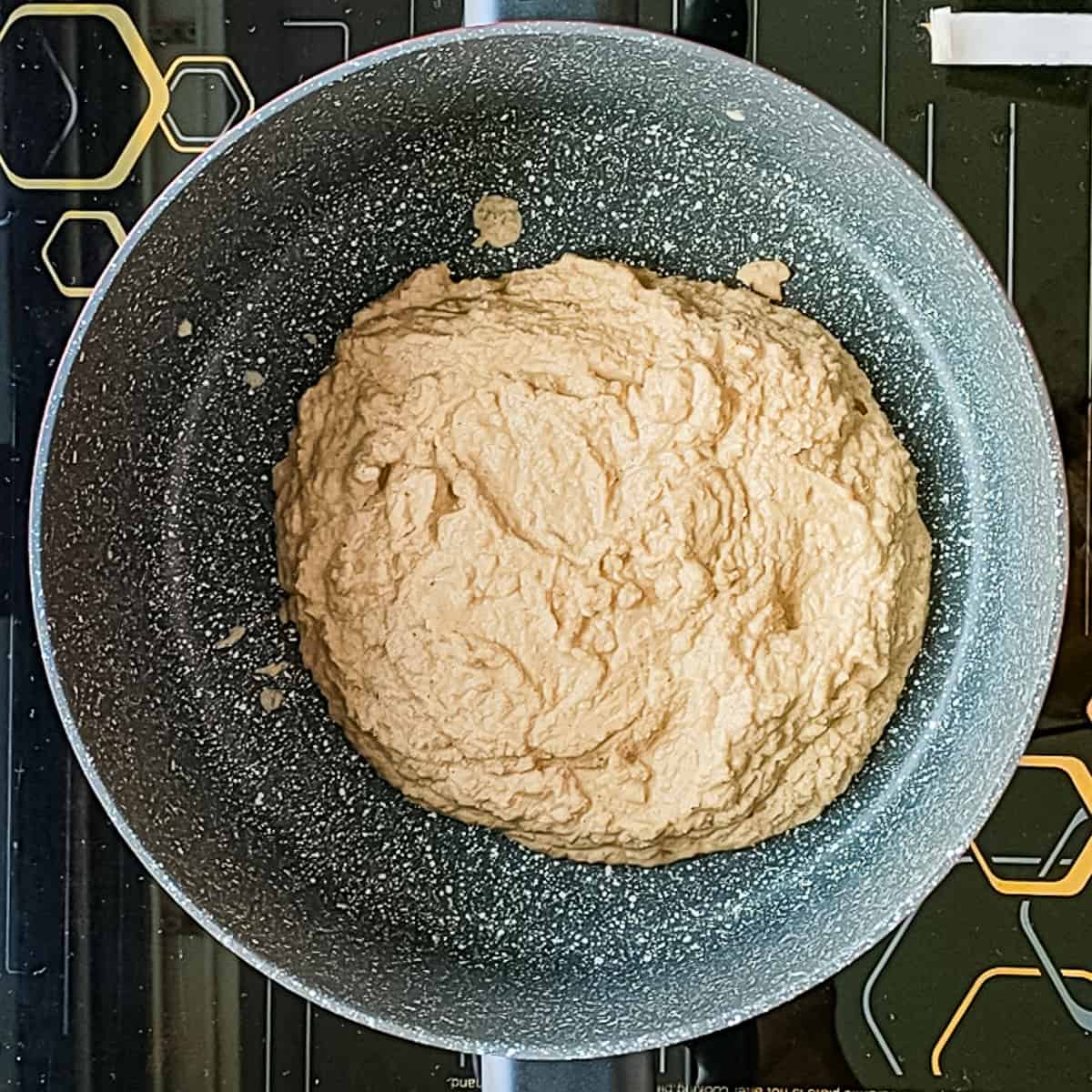 Coconut onion paste in a cooking pot.