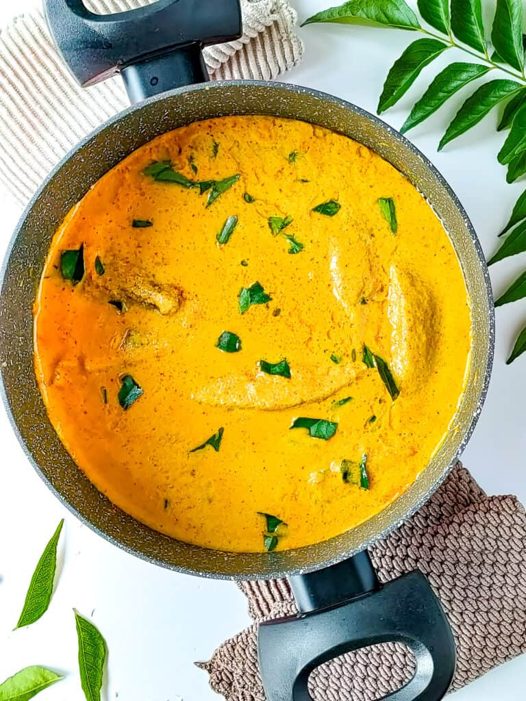 Kerala style fish curry in a pot.