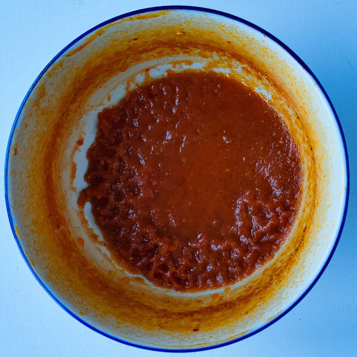 homemade tomato paste (spaghetti sauce secret ingredient) in a white bowl.