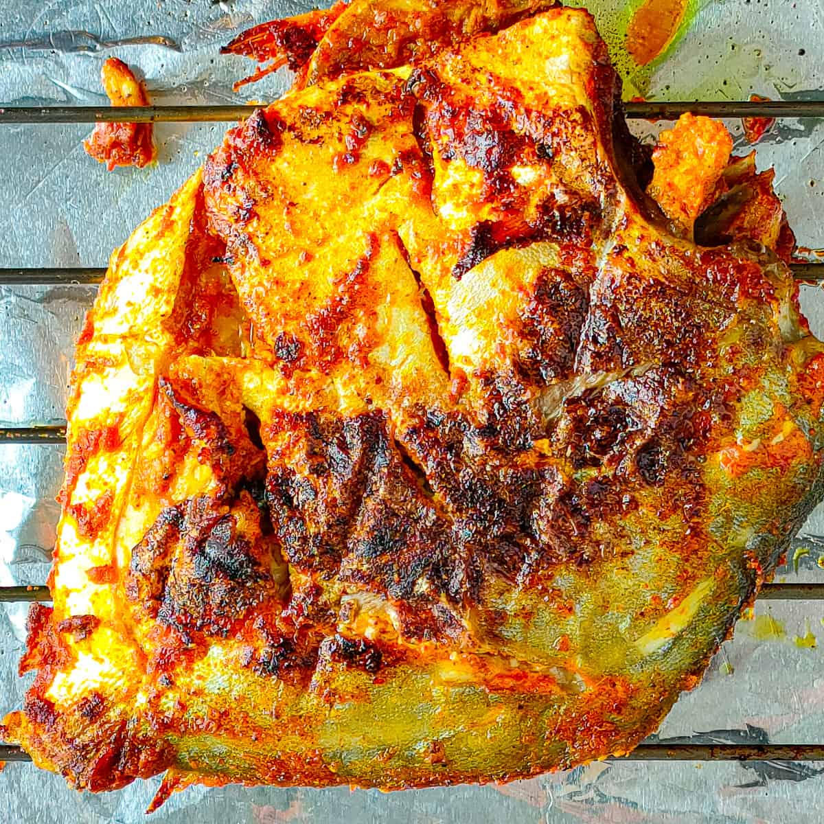 Roasted fish tandoori on an oven grill.