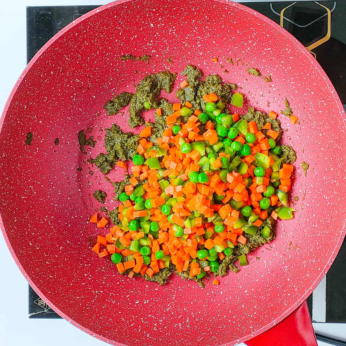 Mixed vegetables being cooked in a wok pan.
