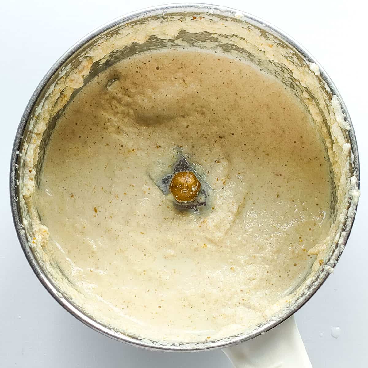 Blended coconut paste in a blender jar.