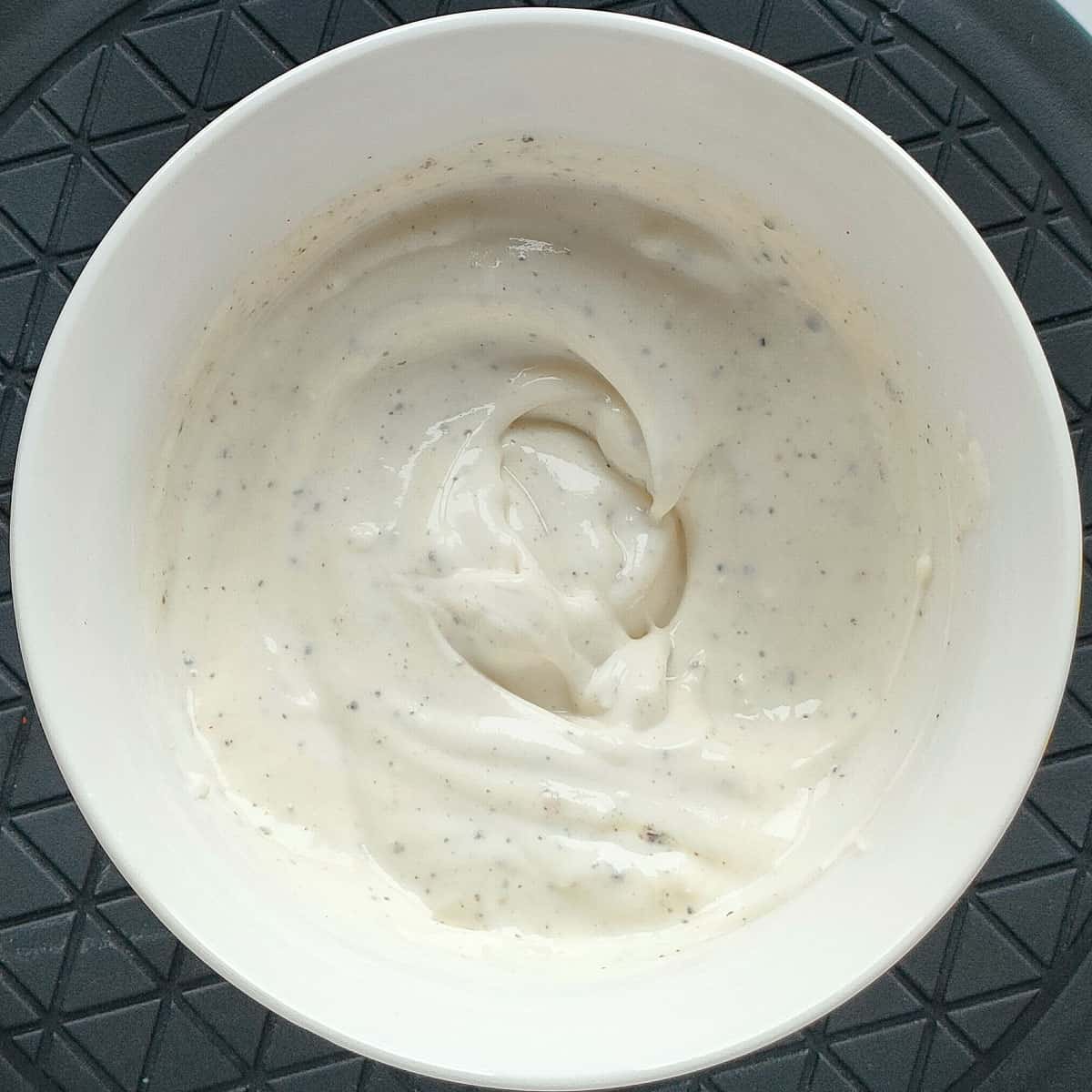 Yogurt sauce for chicken tikka roll in a small bowl.