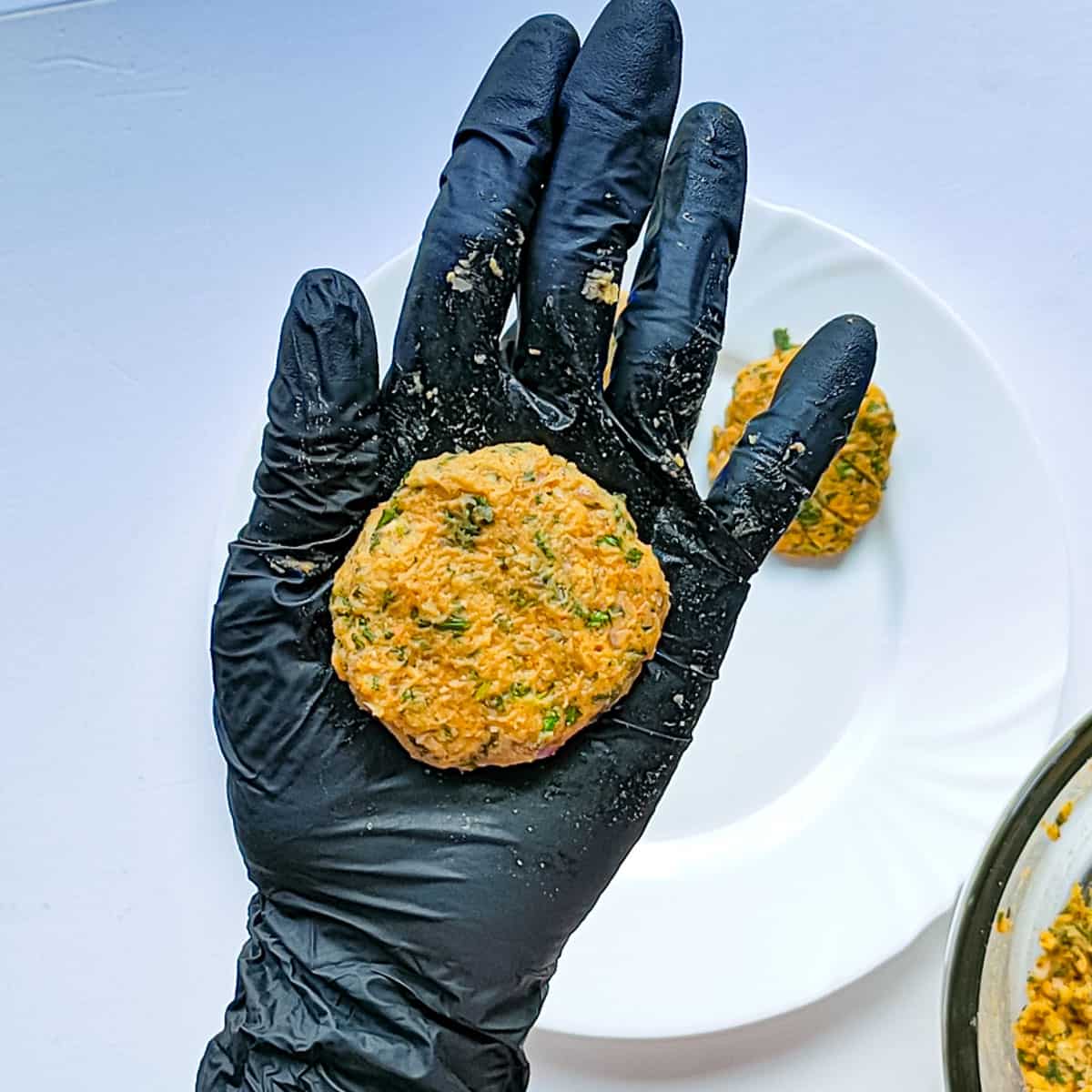 Chana cutlet being shaped into a round on the palm, ready to be fried.