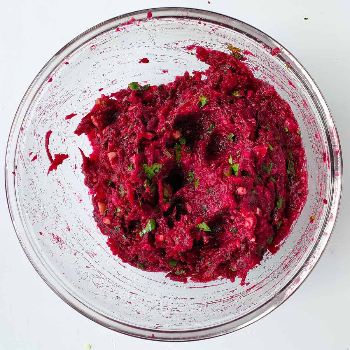 Mixture for making beetroot cutlets in a glass bowl.