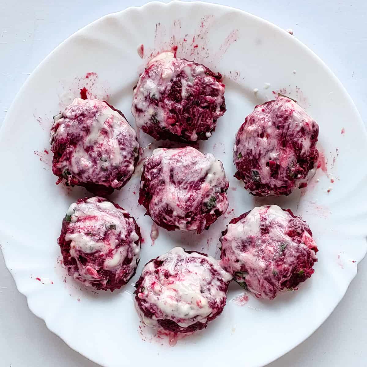 Beetroot tikkis brushed with flour-water mixture before baking.